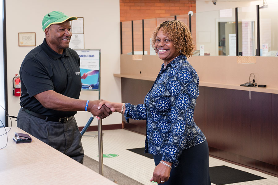 Employee shaking hands with a customer